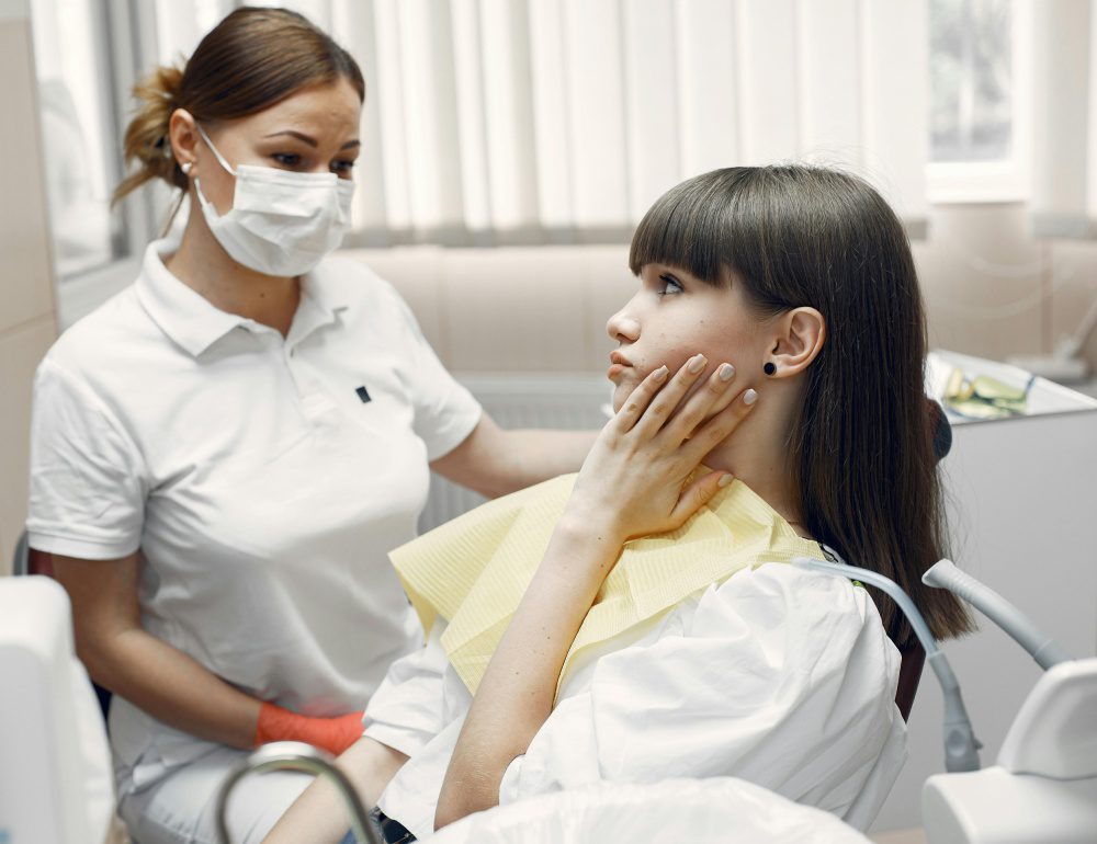 A woman sitting in front of another person.